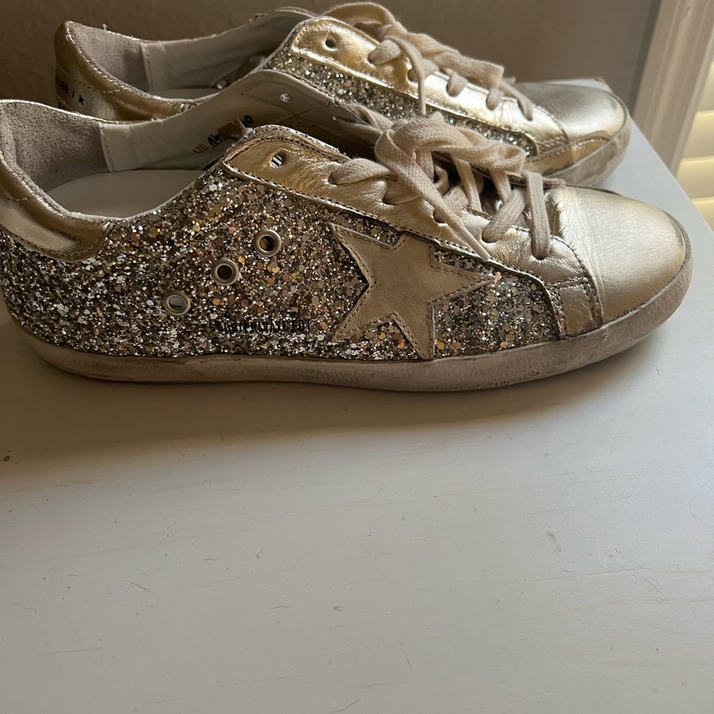 Women’s gold glitter Golden Goose sneakers